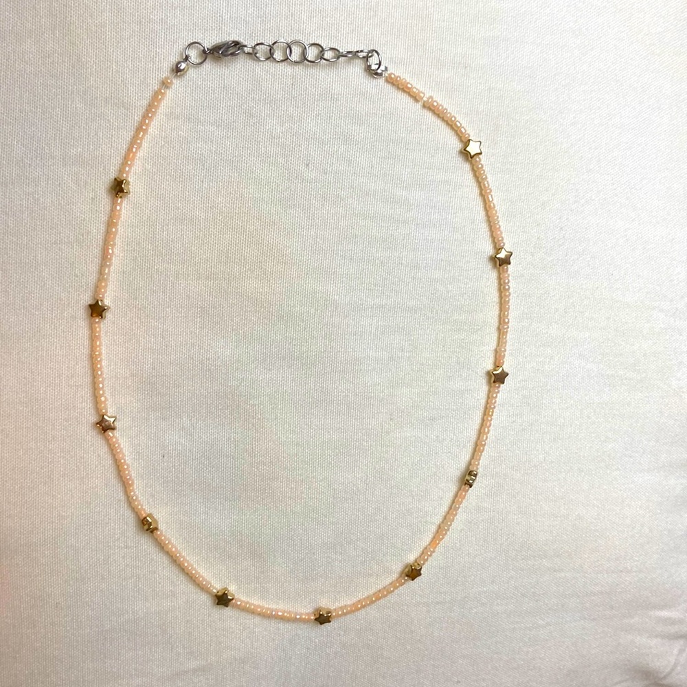 Light pink beaded necklace with gold stars